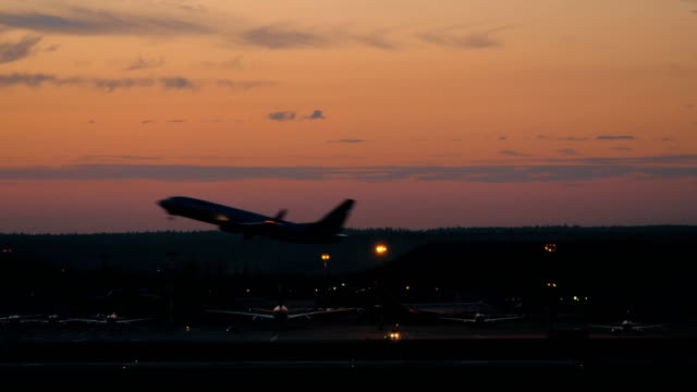 Airport-with-plane-taking-off-in-the-dusk