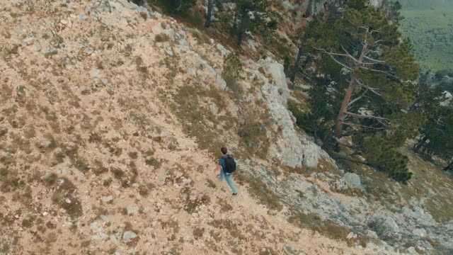 Aerial-view-man-with-backpack-hiking