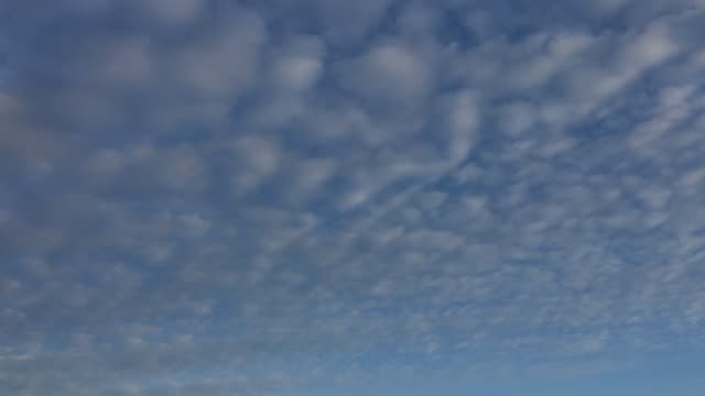 Cloudy-sky.-White-clouds-disappear-in-the-hot-sun-on-blue-sky.-Time-lapse-motion-clouds-blue-sky-background.-Blue-sky-with-white-clouds-and-sun.