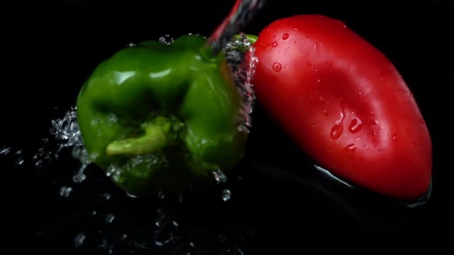 The-stream-of-water-flows-on-pepper.-Slow-motion.