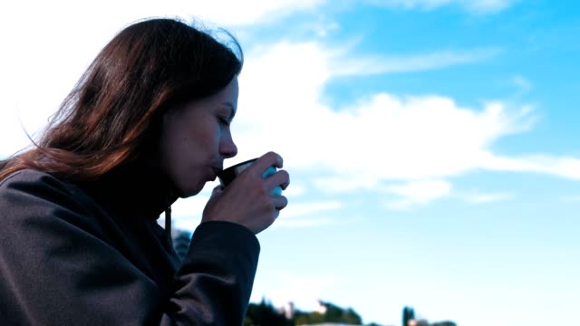 Woman-drinking-a-tea.-Young-brunette-on-a-journey.