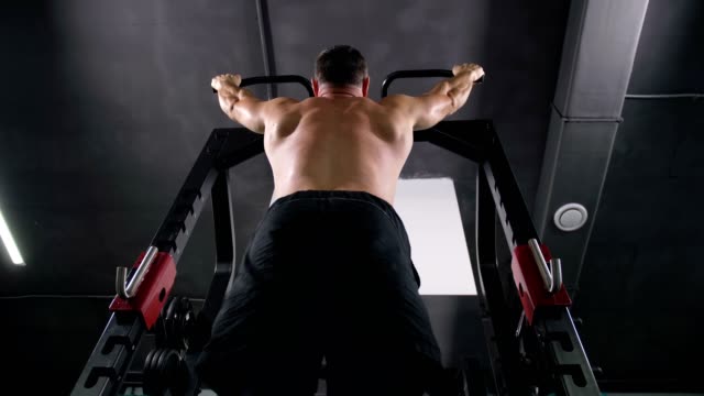 Bottom-view.-Bodybuilder-does-pull-ups-on-horizontal-bar-4K-Slow-Mo