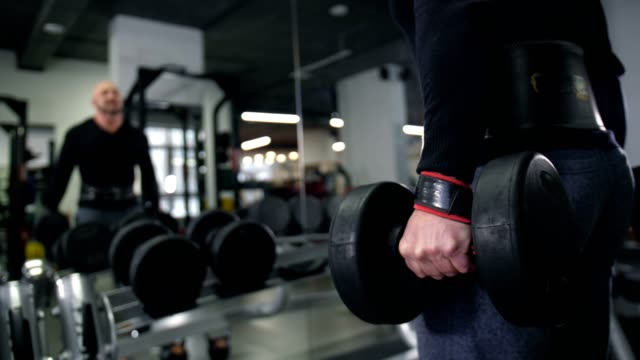 Close-up.-Male-hand-lifts-the-dumbbell-4K-Slow-Mo