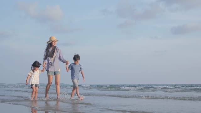 SLOW-MOTION,-alleinerziehende-Mutter,-die-mit-Sohn-und-Tochter-am-Strand-zusammen-spaziert.-Familien-,-Urlaubs-und-Reisekonzept.