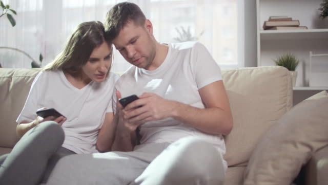 Young-Couple-Looking-at-Phones