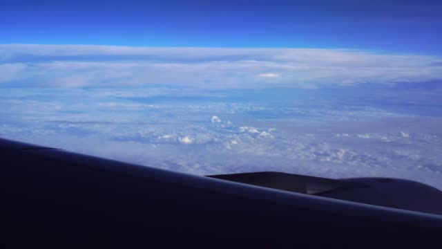 Airplane-window-view-of-clouds-from-passenger-seat