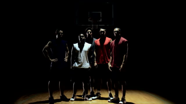 Group-of-basketball-players,-posing-on-the-court.