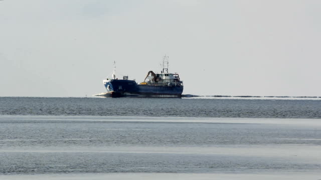 Cargo-ship-with-ports-crane-bridge-coming-in-port