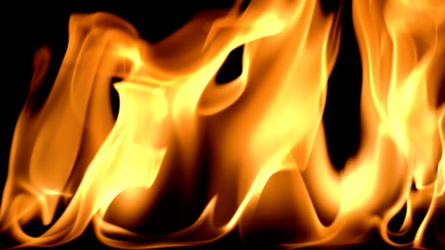 Slow-movement-of-clean-fire,-igniting-and-burning.-On-a-black-background,-a-line-of-real-flames-is-lit.-Real-shots.