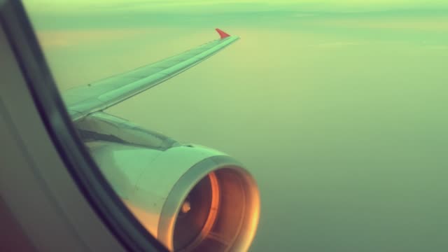 Wing-and-engine-of-airplane-flying-on-sky-and-cloud-on-beautiful-view