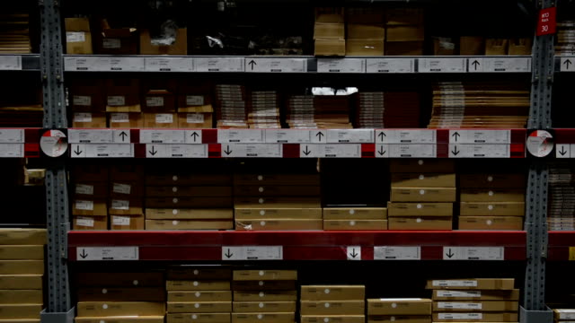 Camera-moves-up-on-shelves-with-box-in-warehouse