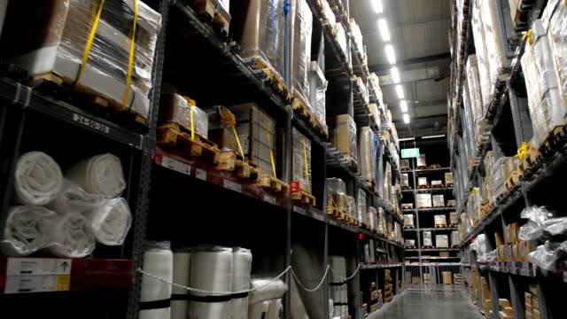 Camera-moves-in-huge-industrial-warehouse,-business-shipping-and-cargo-storage-for-export