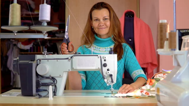 Woman-seamstress-working-in-sewing-studio.