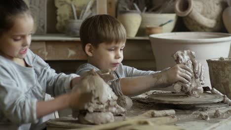 Cute-Children-Sculpting-in-Pottery-Class