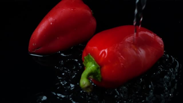 The-stream-of-water-flows-on-pepper.-Slow-motion.