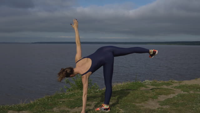 Young-girl-standing-on-one-leg,-balance-training,-yoga