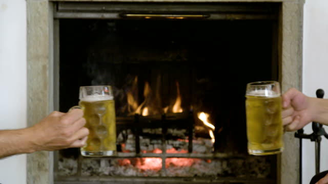 Beer-toast-in-front-of-the-fireplace