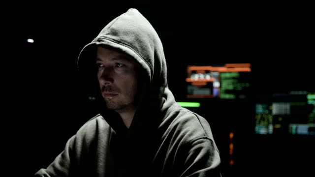 Computer-hacker-with-hoodie-working-with-computers
