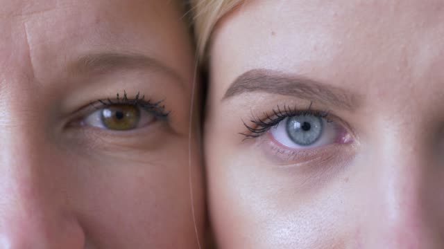 generational-comparison,-eyes-of-caucasian-mom-and-daughter-next-to-one-another-looking-together-at-camera