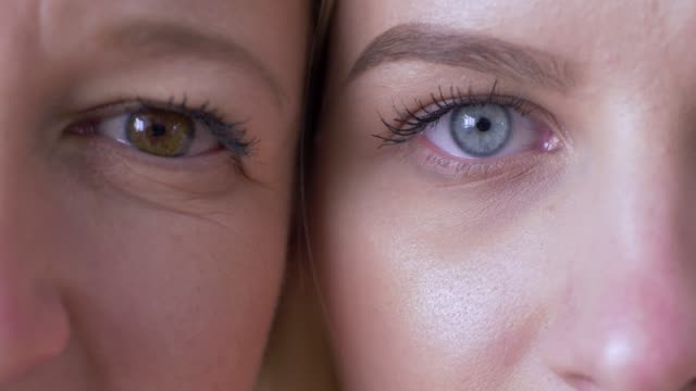 generation-difference,-eyes-of-mum-and-daughter-faces-next-to-one-another-looking-together-at-camera