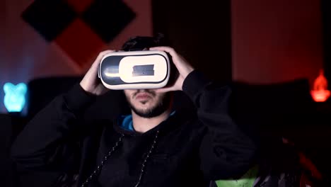 Male-gamer-preparing-for-gaming-session-with-white-VR-glasses