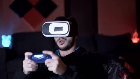 Male-gamer-warming-and-flexing-fingers-before-starting-game-with-VR-glasses-and-controller