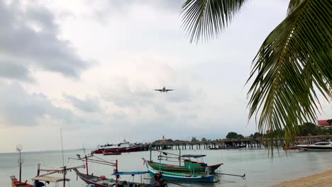 Plane-Flying-Close-Over-Head-and-Landing-Nearby-at-Samui-island,-Thailand.