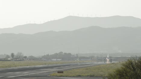 Passenger-airplane-taking-off-from-runway-of-airport-at-sunset