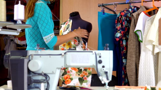 Woman-tailor-working-in-dressmaking-studio.
