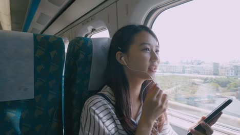 Woman-using-smartphone-on-train