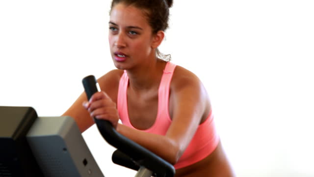 Fit-brunette-working-out-on-the-exercise-bike