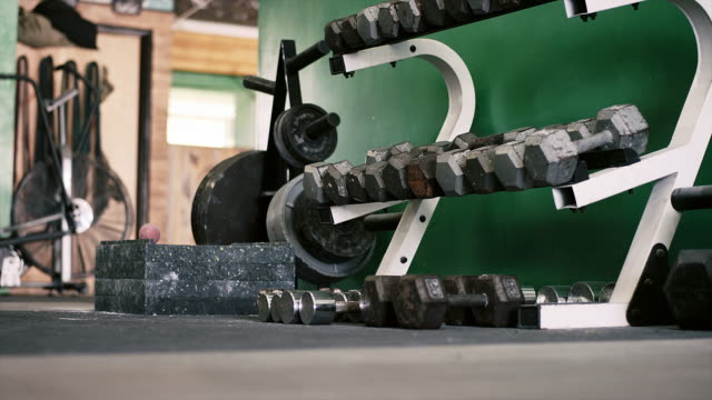 A-rack-of-dumbbells-in-a-small-gym-going-out-of-focus