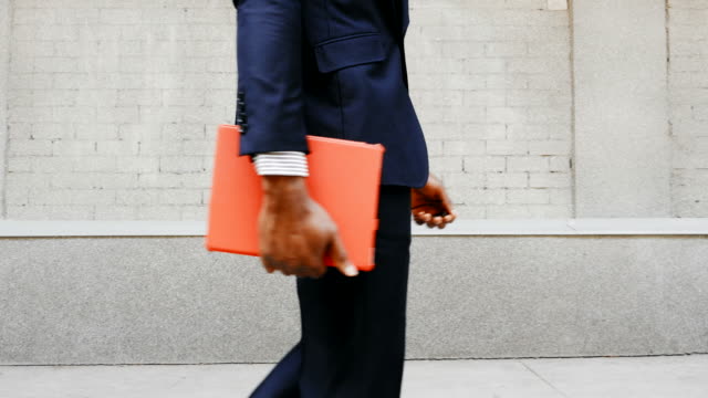 African-American-businessman-walk-with-tablet-outdoors