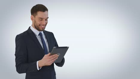 Mid-Shot-of-a-Smiling-Businessman-Using-Tablet-Computer.-Shot-on-a-White-Background.