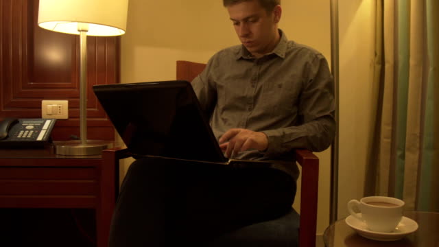 Man-using-laptop-in-home-interior.