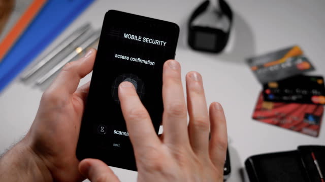 Secure-and-quick-access-to-your-account-with-fingerprint-scanning.-The-application-on-the-smartphone,-the-man-applies-his-finger-to-the-scanner,-the-program-allows-access