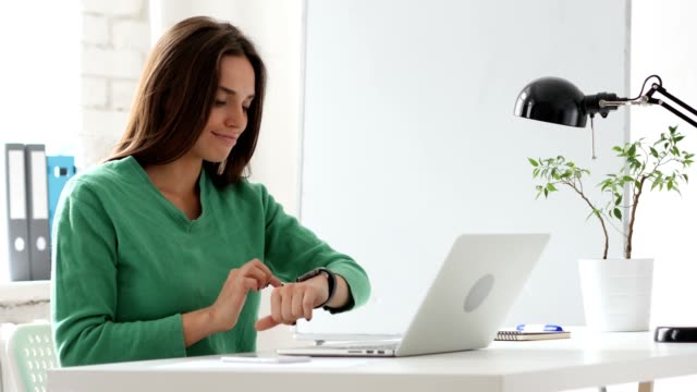 Creative-Woman-Using-Smartwatch,-Browsing