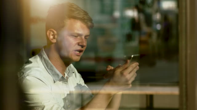 Young-Blond-Man-Having-a-Video-Conference-Via-Digital-Tablet.-Smiling-and-Communicating-to-his-Friend-and-Colleague.
