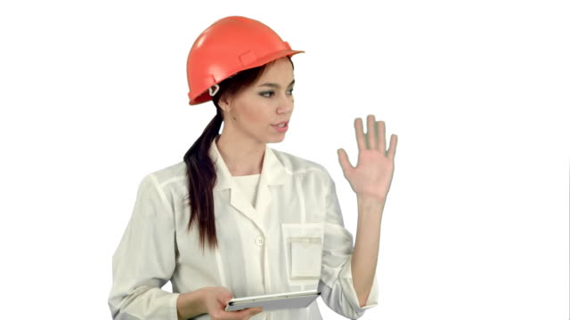 Smiling-female-engineer-with-digital-tablet-taking-to-the-camera-on-white-background