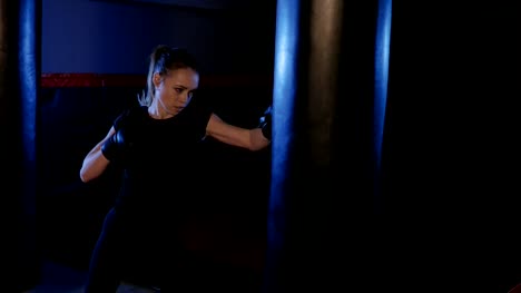 Girl-is-boxing.-Beautiful-kickboxing-woman-training-punching-bag