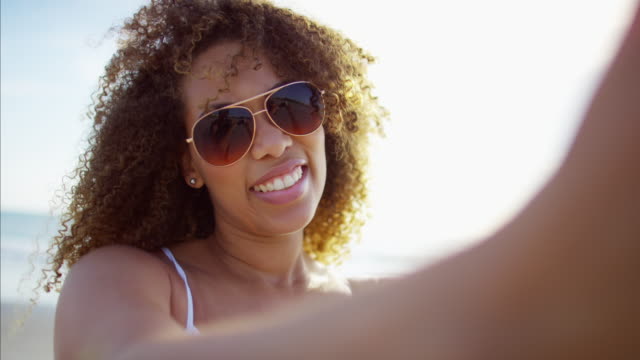 African-American-female-taking-selfie-photo-on-beach