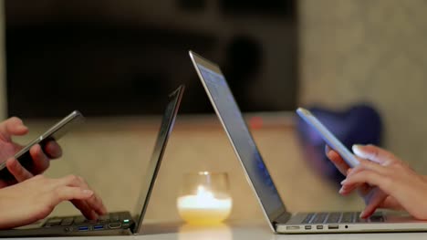 Couple-Student's-Hands-Working-on-Smart-Phone-and-Laptops-CLOSE-UP