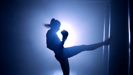 Girl-boxer-workout-in-a-boxing-club.-Silhouette