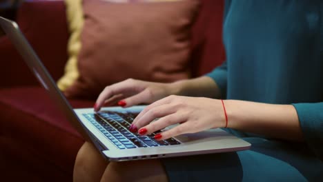 Woman-hands-typing-text-on-keyboard-during-working-on-laptop-computer