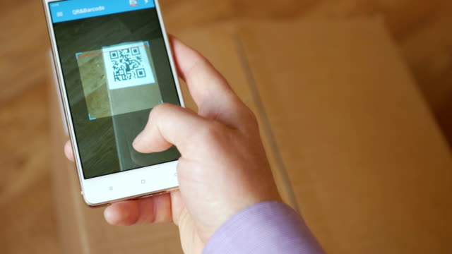 Scanning-QR-code-with-smart-phone.-The-man-reads-the-bar-code-using-the-application-on-the-smartphone.