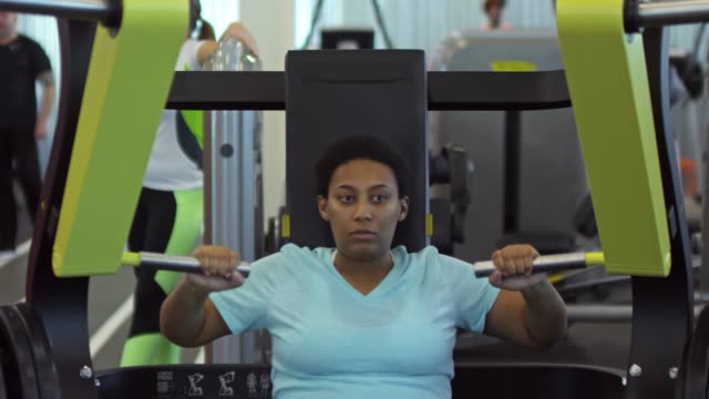 Black-Woman-Training-with-Chest-Press-Machine
