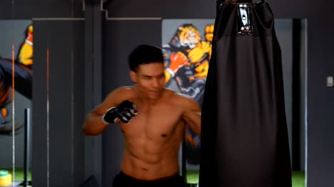 Asian-men's-exercise-with-boxing-in-a-gym.-Living--healthy-lifestyle-concept.