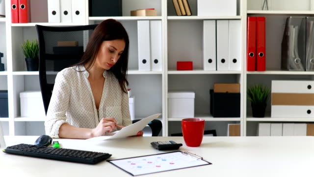 businesswoman-sitting-in-office-chair-and-working-in-white-office