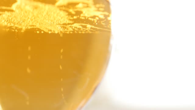 Glass-full-of-beer-slow-tilt-bubbles-and-foam-4K-2160p-UltraHD-footage