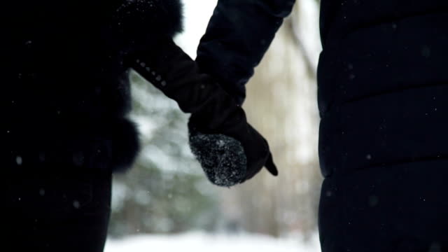 Man-and-Woman-Hold-Hands-in-Winter